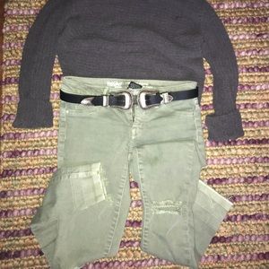 Lightly distressed mid rise green jeans